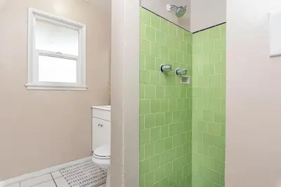 a bathroom with a shower with green tiles at Peaceful Lido Island 3Br, Walk To Bay, Beach And Shopping By Beachview Rentals in Newport Beach