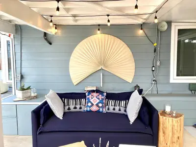 a blue room with a blue couch and a yellow umbrella at The Lantern House, Walk to Harbor, Great Outdoors in Dana Point