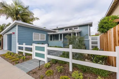 a blue house with a white fence at The Lantern House, Walk to Harbor, Great Outdoors in Dana Point