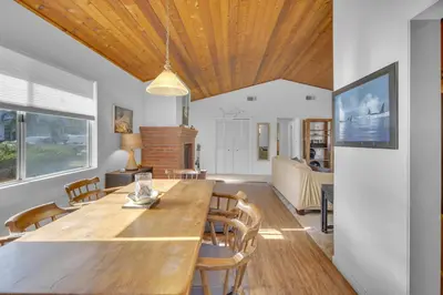 a dining room with a large wooden table and chairs at 2 Blocks to Beach, Firepit, Sandbox, BBQ, Work in Carlsbad