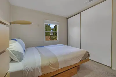 a bedroom with a bed and a window at 2 Blocks to Beach, Firepit, Sandbox, BBQ, Work in Carlsbad