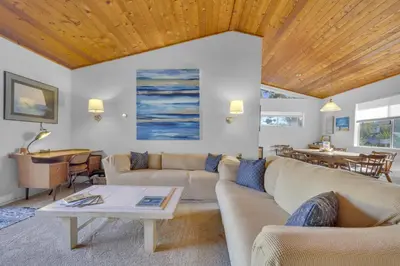 a living room with a couch and a table at 2 Blocks to Beach, Firepit, Sandbox, BBQ, Work in Carlsbad