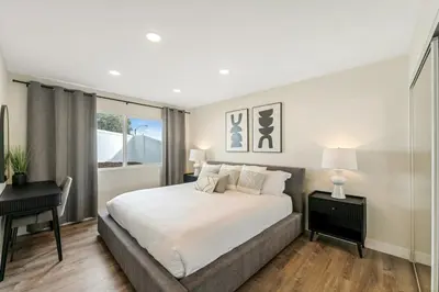 a bedroom with a bed and a desk and a window at Neat Retreat w Hot Tub Near Beach and Downtown in San Diego