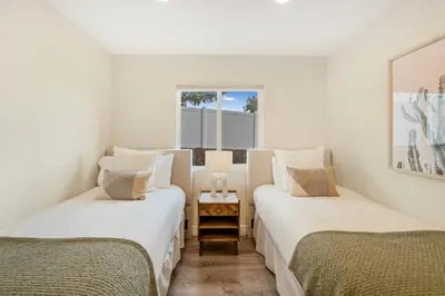two twin beds in a room with a window at Neat Retreat w Hot Tub Near Beach and Downtown in San Diego