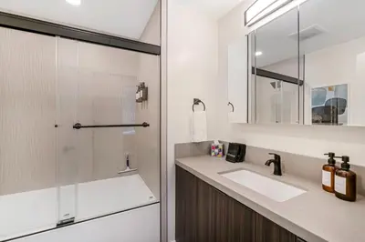 a bathroom with a sink and a shower at Neat Retreat w Hot Tub Near Beach and Downtown in San Diego