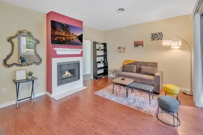 a living room with a couch and a fireplace at Heart of Carmel Valley 2BR, Families and Corp Stays in San Diego