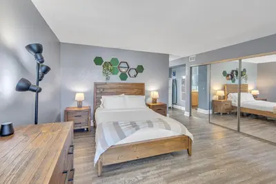 a bedroom with a large bed and a large mirror at Point Loma 2BR Townhome w Parking in Prime Location in San Diego