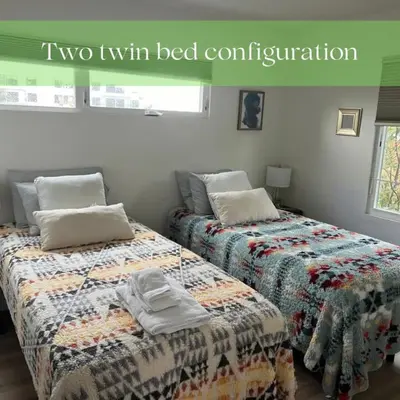 two twin beds sitting next to each other in a bedroom at Private Rooftop Retreat with Stunning City Views in San Diego