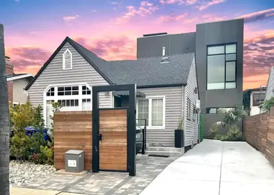 a house with a wooden gate in front of it at Private Rooftop Retreat with Stunning City Views in San Diego