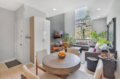 a living room with a table and a couch at Little Italy Urban Designer Loft Parking, WandD, AC in San Diego