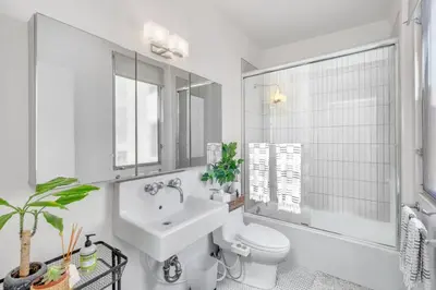 a white bathroom with a sink and a toilet at Little Italy Urban Designer Loft Parking, WandD, AC in San Diego