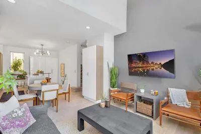 a living room with a couch and a table at Little Italy Urban Designer Loft Parking, WandD, AC in San Diego
