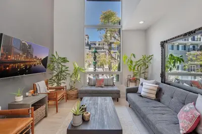 a living room with a couch and a table at Little Italy Urban Designer Loft Parking, WandD, AC in San Diego