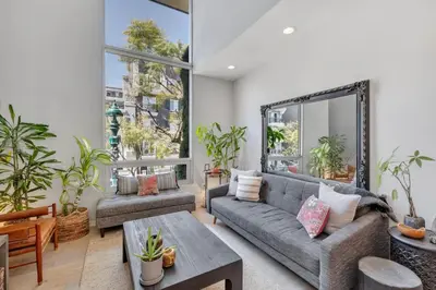 a living room with a couch and a table at Little Italy Urban Designer Loft Parking, WandD, AC in San Diego