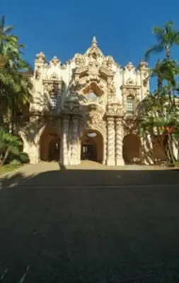 a white building with a palm tree in front of it at Studio w Private Entrance Convenient and Cozy in San Diego