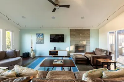 a living room with a couch and a table at San Diego Staycation Home with Hot Tub Ocean Views in Encinitas