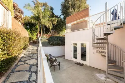 a house with a staircase and a patio at San Diego Staycation Home with Hot Tub Ocean Views in Encinitas
