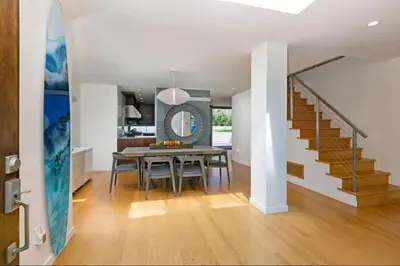 a dining room with a table and a staircase at Sunset Cliffs Dream Home Ocean View Family Getaway in San Diego
