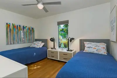 a bedroom with two beds and a ceiling fan at Sunset Cliffs Dream Home Ocean View Family Getaway in San Diego