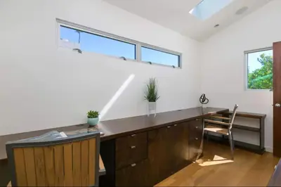 an office with a desk with a chair and windows at Sunset Cliffs Dream Home Ocean View Family Getaway in San Diego