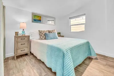 a bedroom with a bed and a dresser and a window at North Park 1BR Cottage Prime Location with Parking in San Diego