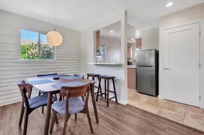 a kitchen with a table and chairs and a refrigerator at Comfortable Carlsbad 2BR Beach Home Walk to Beach in Carlsbad