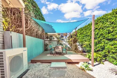 a patio with a table and chairs and a fence at Comfortable Carlsbad 2BR Beach Home Walk to Beach in Carlsbad