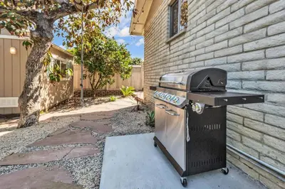 a grill sitting on a sidewalk next to a building at Comfortable Carlsbad 2BR Beach Home Walk to Beach in Carlsbad