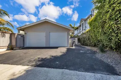 a house with a garage on the side of a driveway at Comfortable Carlsbad 2BR Beach Home Walk to Beach in Carlsbad