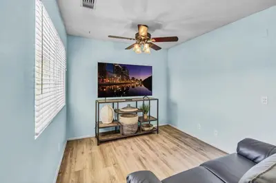 a living room with a ceiling fan and a couch at Stunning 4BR Laguna Hills Oasis with Private Pool in Laguna Hills