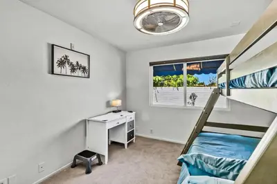 a bedroom with a bunk bed and a desk at Stunning 4BR Laguna Hills Oasis with Private Pool in Laguna Hills