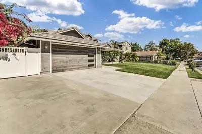 a house with a garage and a driveway at Stunning 4BR Laguna Hills Oasis with Private Pool in Laguna Hills