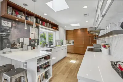 a kitchen with white countertops and wooden cabinets at Encinitas Beach Family Retreat with Hot Tub in Encinitas
