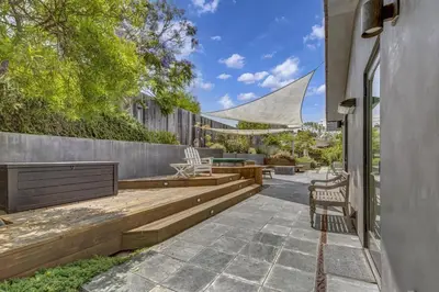 a patio with a table and chairs and a fence at Encinitas Beach Family Retreat with Hot Tub in Encinitas