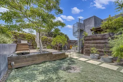 a garden with a tree and a fence at Encinitas Beach Family Retreat with Hot Tub in Encinitas