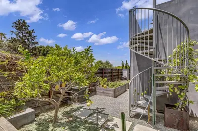 a garden with a spiral staircase and fruit trees at Encinitas Beach Family Retreat with Hot Tub in Encinitas