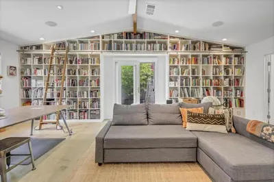 a living room with a couch and bookshelves at Encinitas Beach Family Retreat with Hot Tub in Encinitas