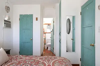 a bedroom with blue doors and a bed and a bathroom at Old Town 1BR Short Drive to Downtown and Beaches 84 in San Diego