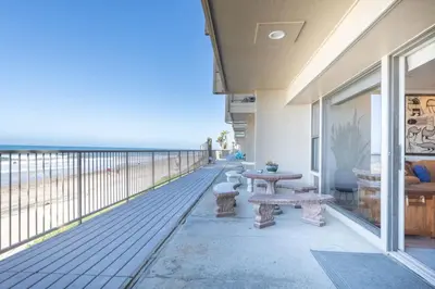 a balcony with benches and a view of the beach at Oceanfront Condo on Sand, Walk to Carlsbad Village in Carlsbad