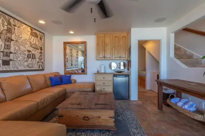 a living room with a couch and a table at Oceanfront Condo on Sand, Walk to Carlsbad Village in Carlsbad