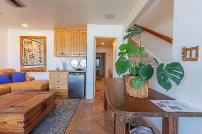 a living room with a couch and a table at Oceanfront Condo on Sand, Walk to Carlsbad Village in Carlsbad