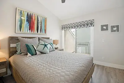 a bedroom with a large bed and a window at Chic Upstairs Condo Steps from Strands Beach in Dana Point