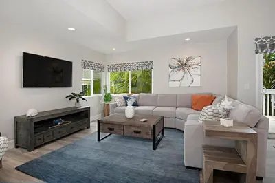 a living room with a couch and a tv at Chic Upstairs Condo Steps from Strands Beach in Dana Point