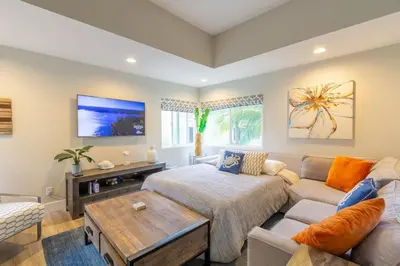 a living room with a couch and a table at Chic Upstairs Condo Steps from Strands Beach in Dana Point