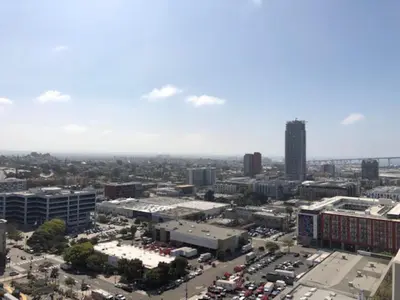 an aerial view of a city with buildings and cars at Modern Downtown SD Apartment Stunning City Views in San Diego