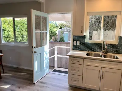 a kitchen with a sink and a door with a window at Staycation Beach Family Home Great Indoor Outdoor in Carlsbad