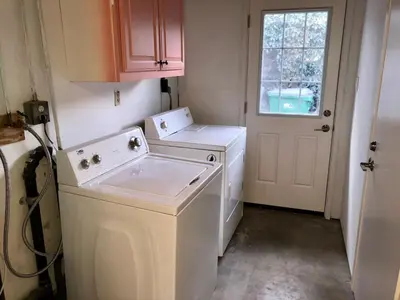 a laundry room with a washing machine and a window at Staycation Beach Family Home Great Indoor Outdoor in Carlsbad