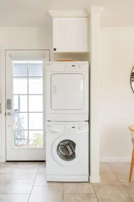 a washer and dryer in a room with a door at Pacific Beach Cottage 1 Walk to the Beach and Bay in San Diego