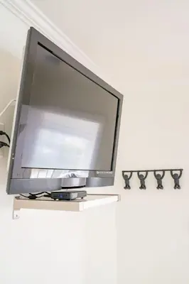 a flat screen tv sitting on top of a table at Pacific Beach Cottage 1 Walk to the Beach and Bay in San Diego