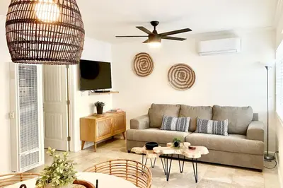 a living room with a couch and a ceiling fan at Pacific Beach Cottage 3 Walk to the Beach and Bay in San Diego